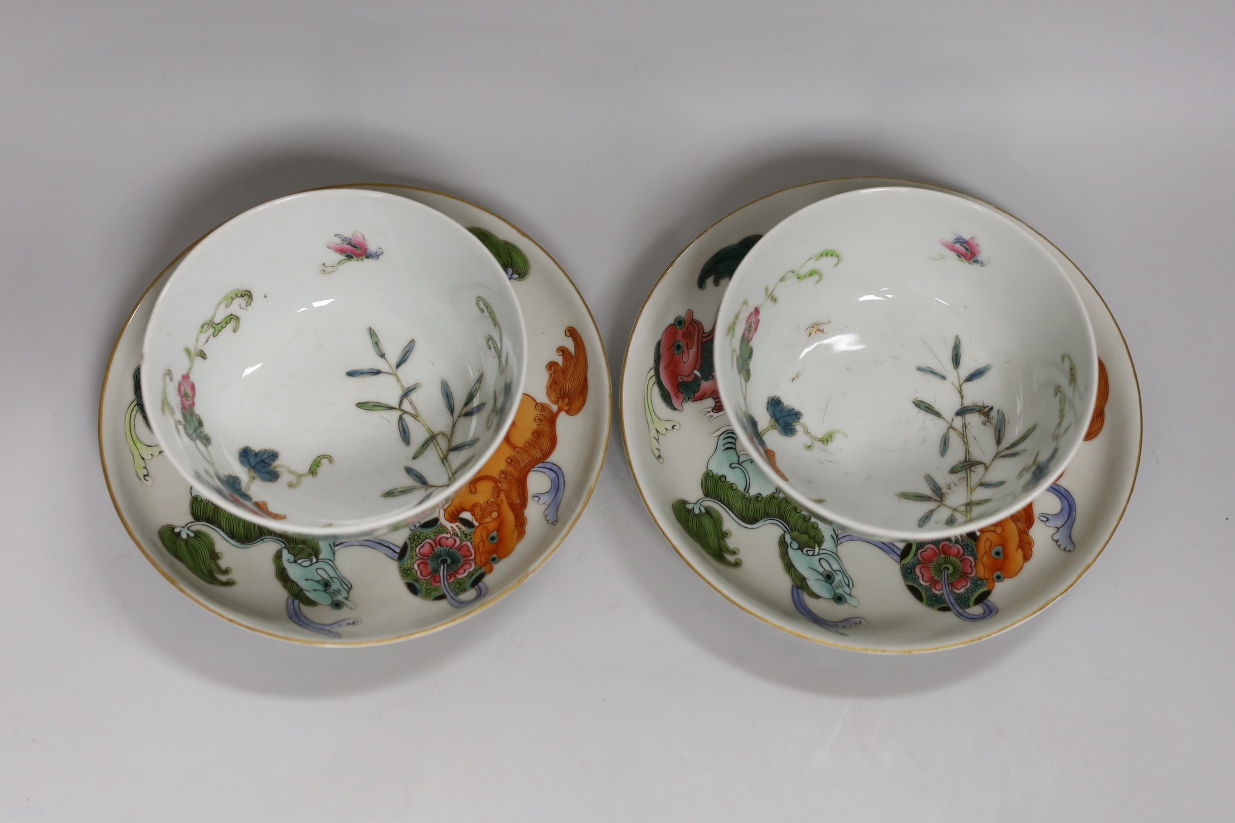 A pair of Chinese famille rose bowls and two similar saucer dishes